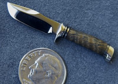 A custom miniature fixed blade knife made by Brian Jacobson.