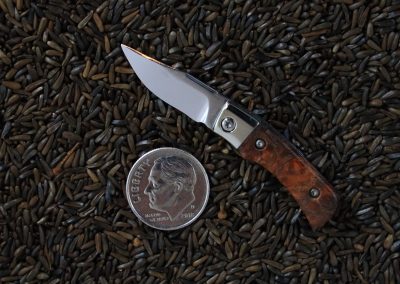 A custom miniature folding knife made by Brian Jacobson.