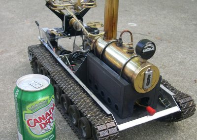 A soda can provides scale reference for the small tank.