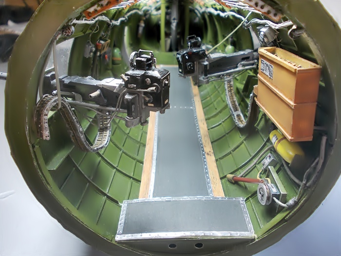 An interior view of of the B-17G fuselage shows both waist guns from the rear.