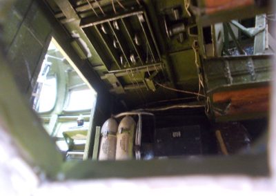 Control cables and equipment are visible through the crew hatch on the port side of the fuselage.