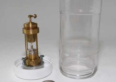 The oscillating micro steam engine itself sits atop a boiler made from a sewing thimble.