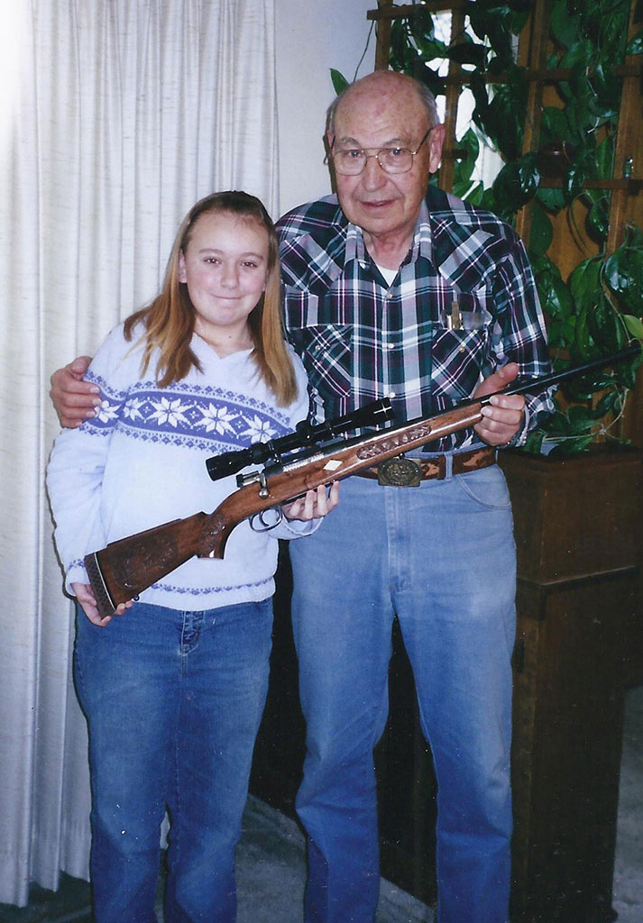 Birk presenting a rifle to one of his granddaughters. 