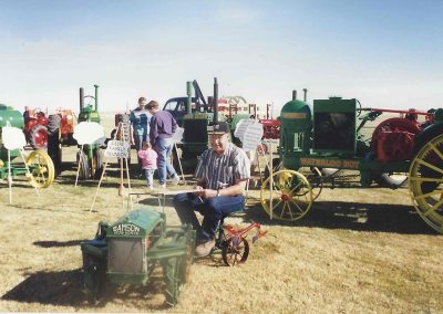 Birk rides behind his scale Iron Horse tractor at a show.