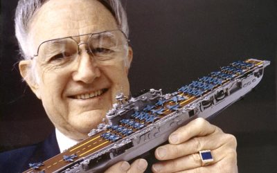 William Tompkins displaying one of 307 model ships in his fleet.