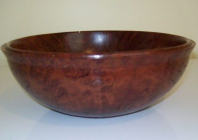A wooden bowl measuring 12" in diameter and 4" deep.