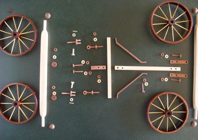 Wheels, axles, and frame components were laid out for assembly.