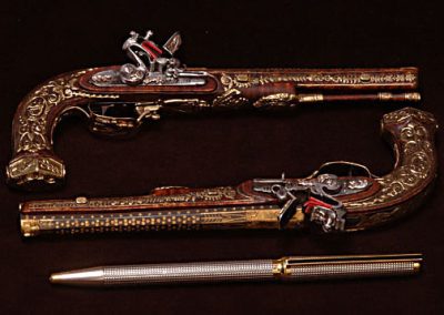 The miniature LeGrand holster pistols.