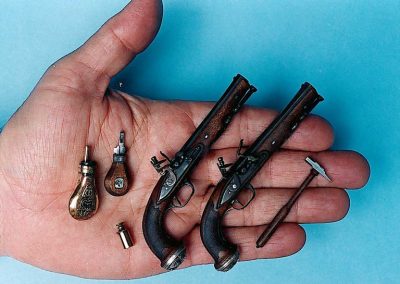 Miniature Medusa pistols with accessories. 