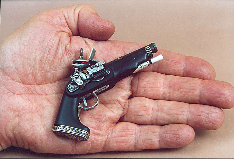 Antonio holds his miniature Spanish Miquelet pistol. 