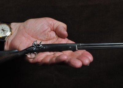 A 1/4 scale single-barreled flintlock hunting shotgun.