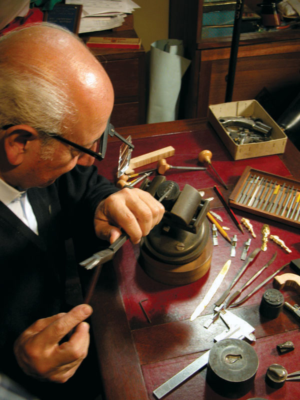 Master miniature gunsmith Antonio Rincón at work on a project.