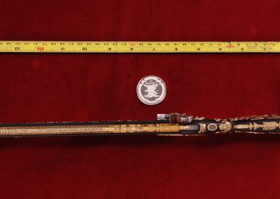 This ornate miniature carbine is about 15” long.