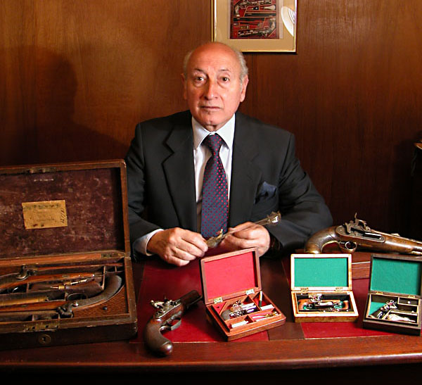 Antonio Rincón, of Columbia, poses with several of his exceptional antique firearms. 