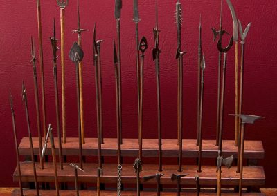 A miniature collection of ancient pikes, battle axes, maces, and more weapons.