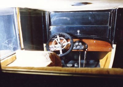 The steering wheel and dash are visible through the rear window.