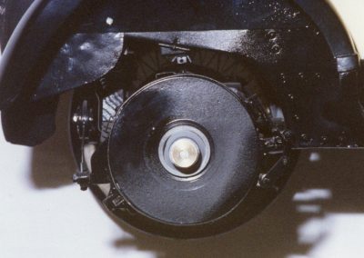The large rear brake drum is visible with the wheel removed.