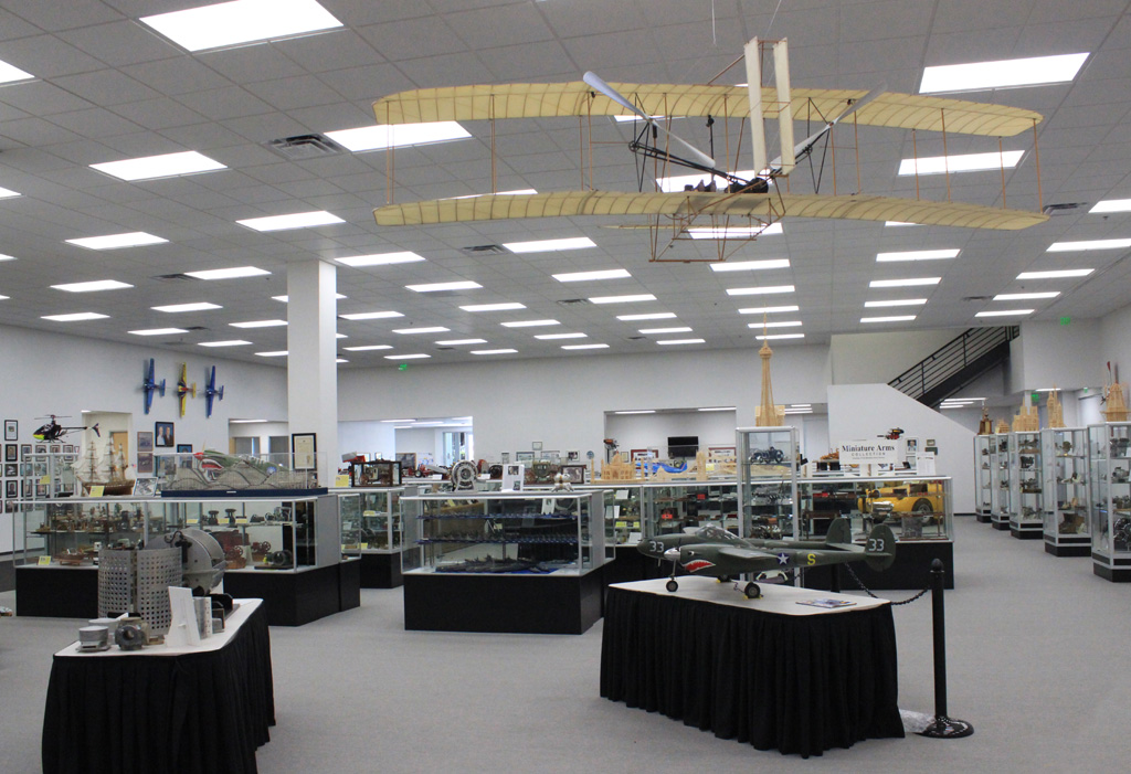 The scale Wright Flyer floats above some display cases. 