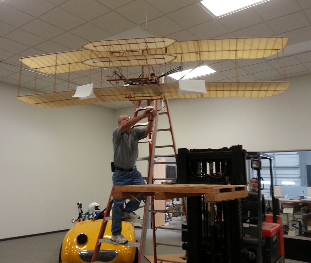 Raising up the scale model Wright Flyer.