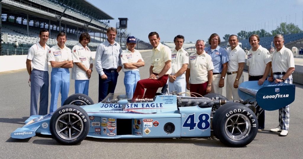 Butch Wilson (to the right of the driver) with the All American Racers team at Indy.