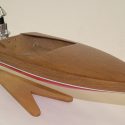 A miniature mahogany flatbottom ski boar with .010 outboard engine.