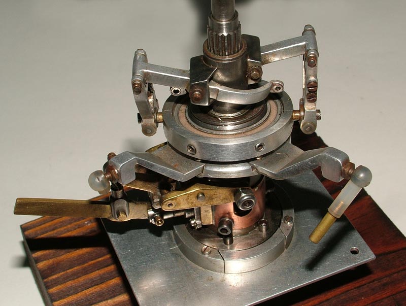 A brass and aluminum miniature Bell helicopter rotor mechanism.