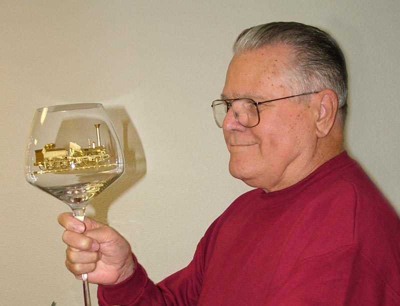 Joe Martin holds up the glass goblet containing the miniature Adler.