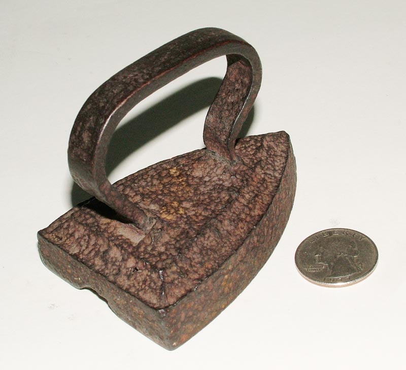 This miniature child's iron dates back over a century, if not more.
