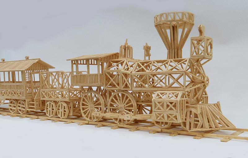 This model steam locomotive with passenger car and tender was made entirely from matchsticks.