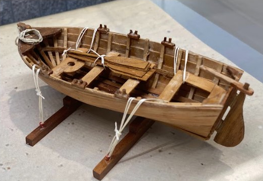 This tiny scratch-built scale model boat would have accompanied a larger ship.