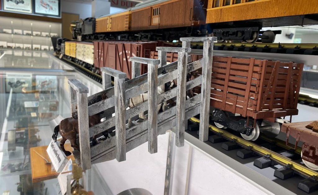 This is a G-scale wooden cattle ramp for a model locomotive scene.