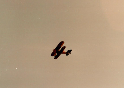 The F4B-2 biplane soars through the skies above.